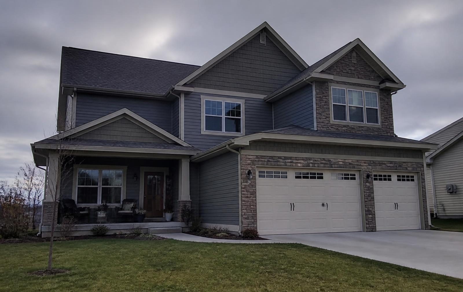 Luxury Edmonton home shown in daylight and illuminated at night during the day