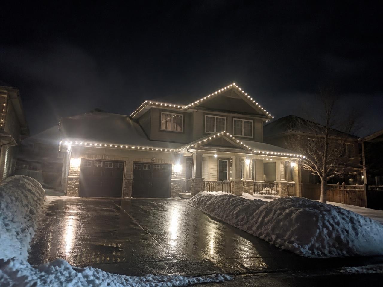 Luxury home in winter snow illuminated at night