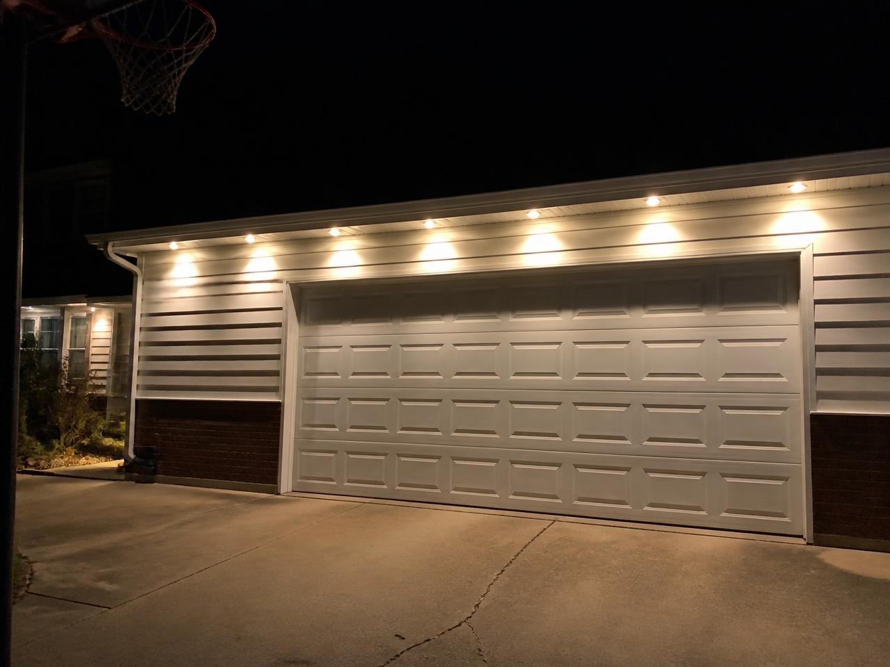 Garage and driveway lit by discreet permanent lighting